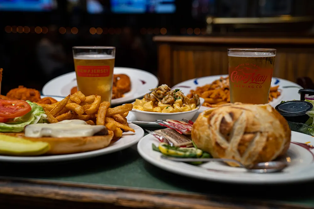 A burger with fries and a Charlie's pint